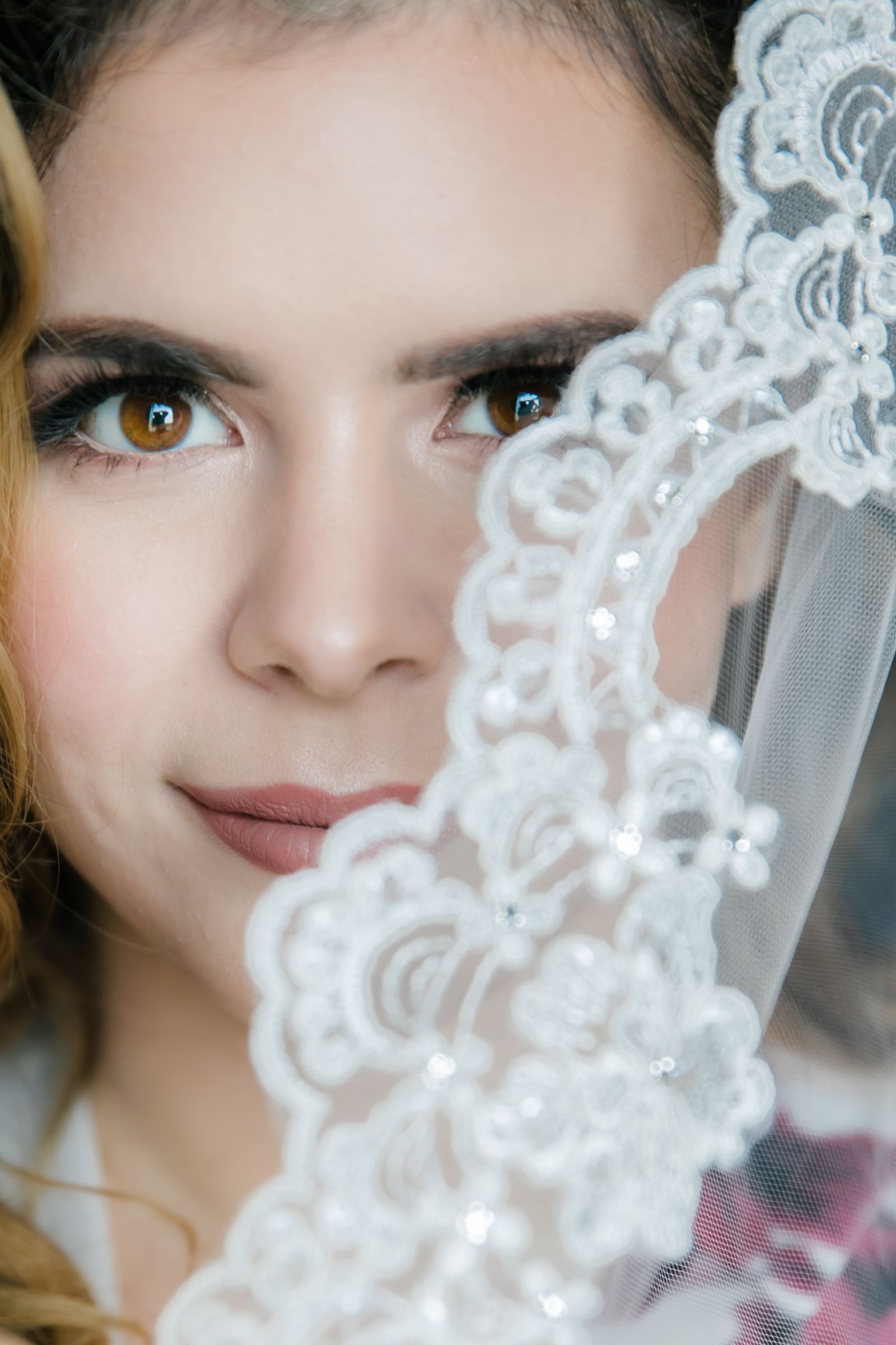 Eyes that tell a love story! A stunning close-up of a bride beneath her veil, capturing elegance, mystery, and timeless beauty. A breathtaking moment of bridal perfection. #BridalBeauty #UnderTheVeil #WeddingPhotography #TimelessElegance #BridalPortrait #EyesThatSpeak