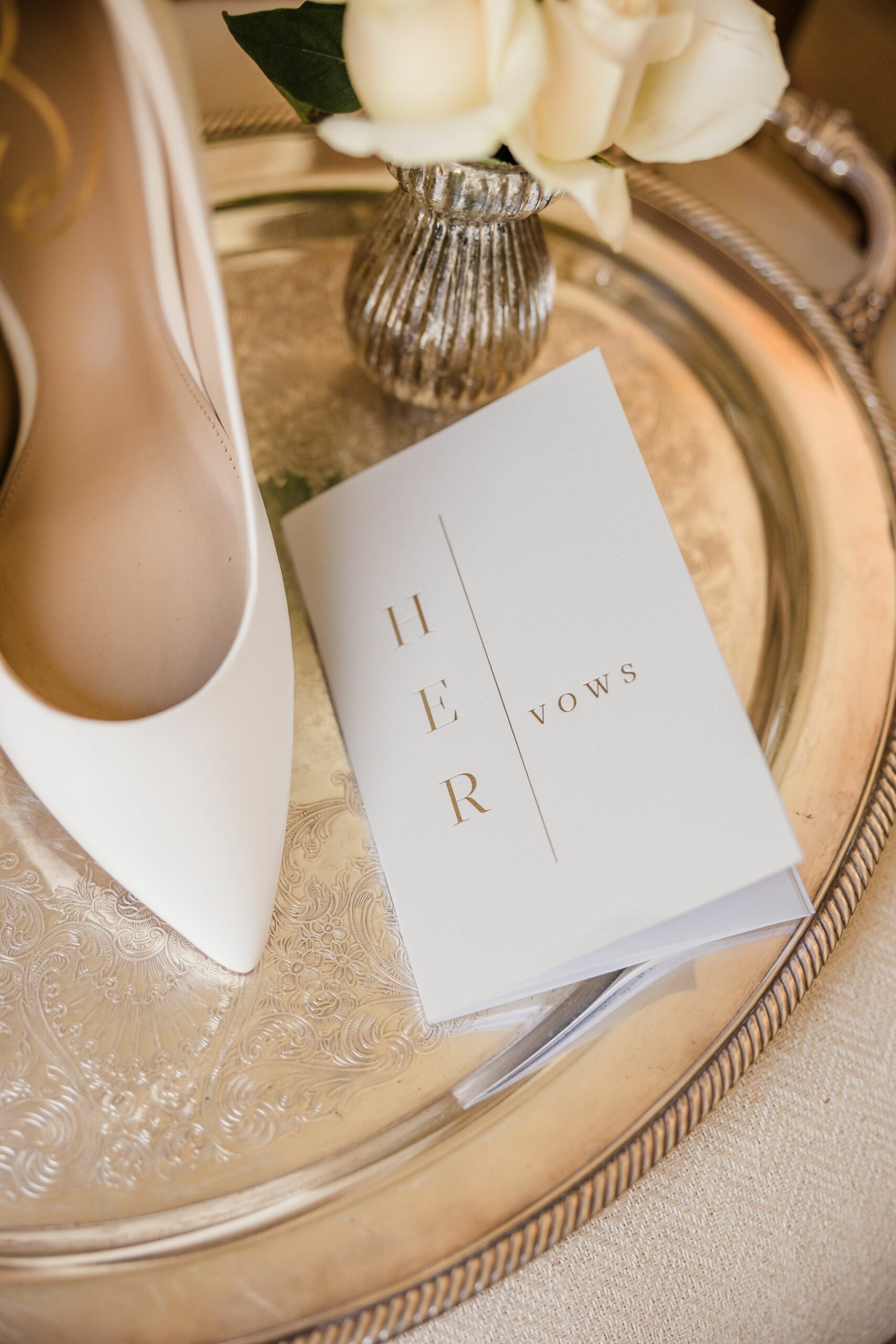 Elegant bridal details that tell a love story! A stunning pair of wedding shoes beautifully placed beside a heartfelt vows book, capturing the essence of romance, commitment, and timeless style. #BridalDetails #WeddingFlatlay #VowsBook #BridalShoes #WeddingInspiration #BrideToBe