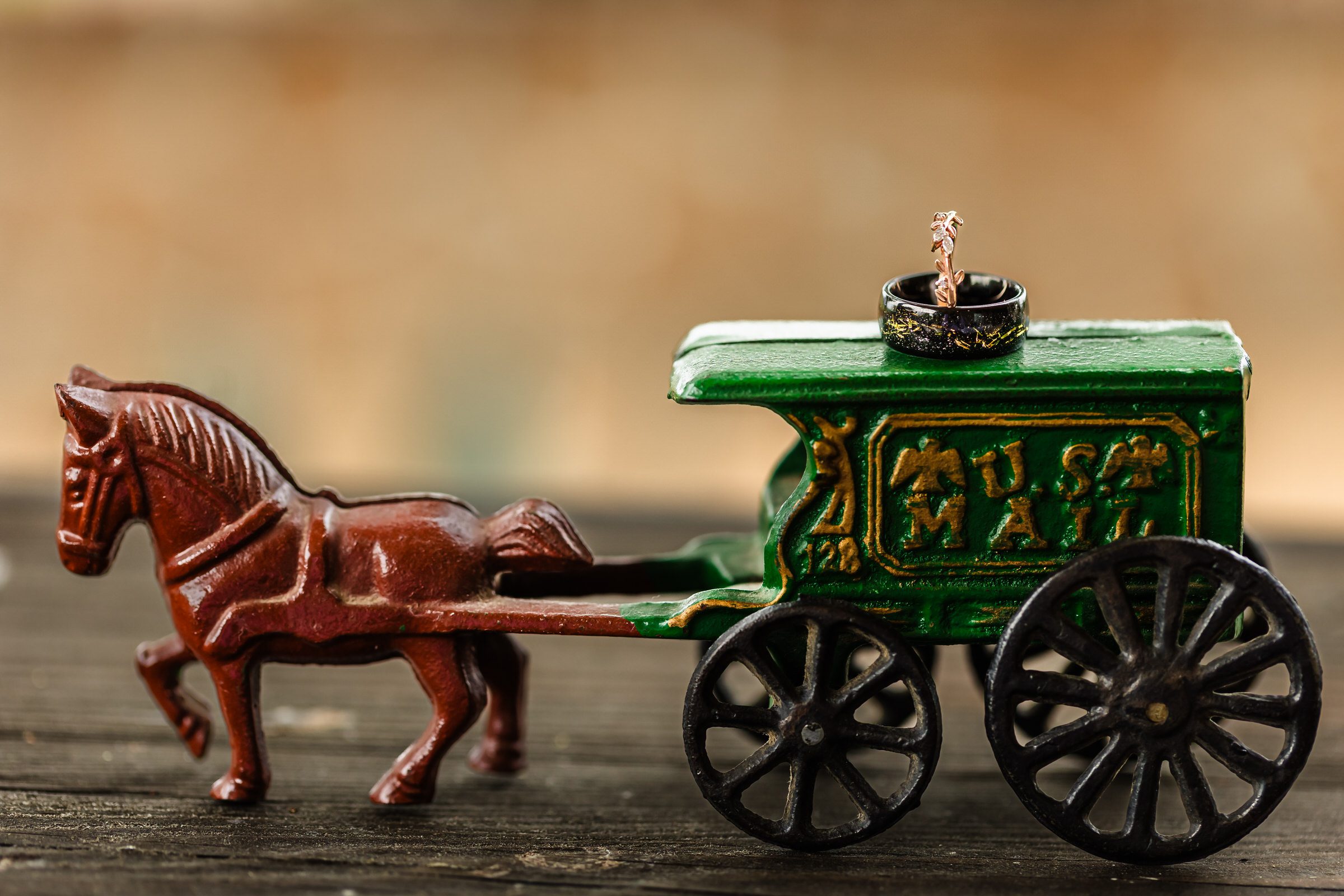 Every detail tells a love story! A delicate toy carriage cradles the wedding rings, symbolizing a fairytale romance and timeless commitment. Thoughtful details like these make wedding photography truly unforgettable. #WeddingDetails #RingPhotography #FairytaleWedding #LoveInTheDetails #TimelessRomance #WeddingStorytelling